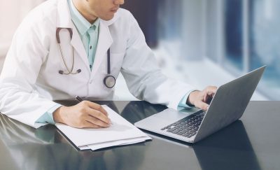 doctor-on-desk-with-table-cropped_613913759-1200 doctor-on-desk-with-table-cropped_613913759-1200